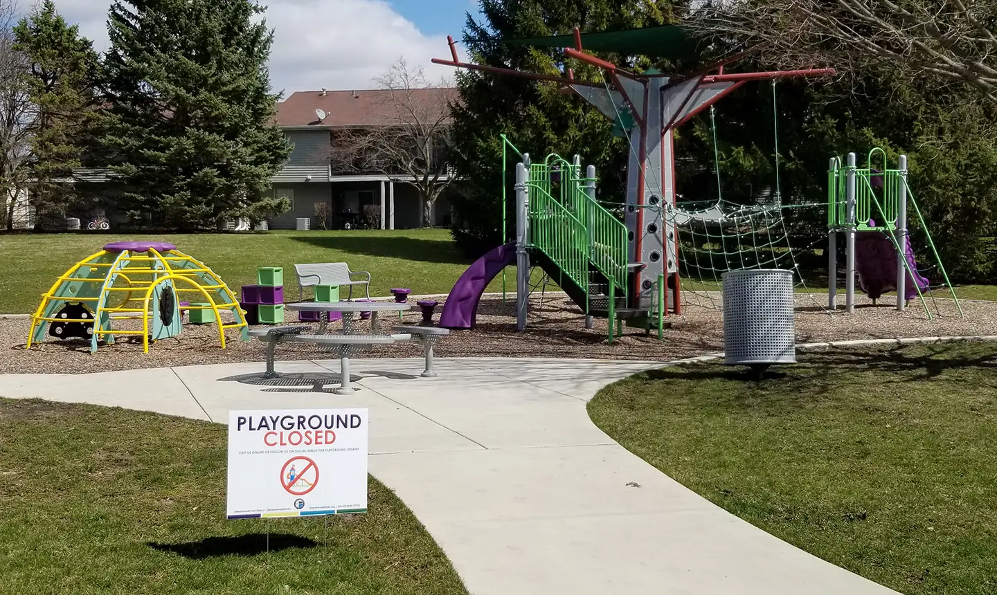 a playground closed with a sign