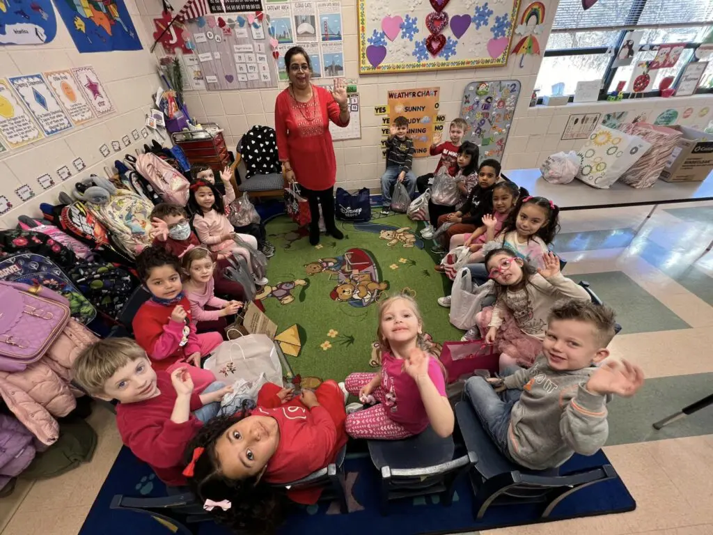a group of children sitting in a circle in a classroom