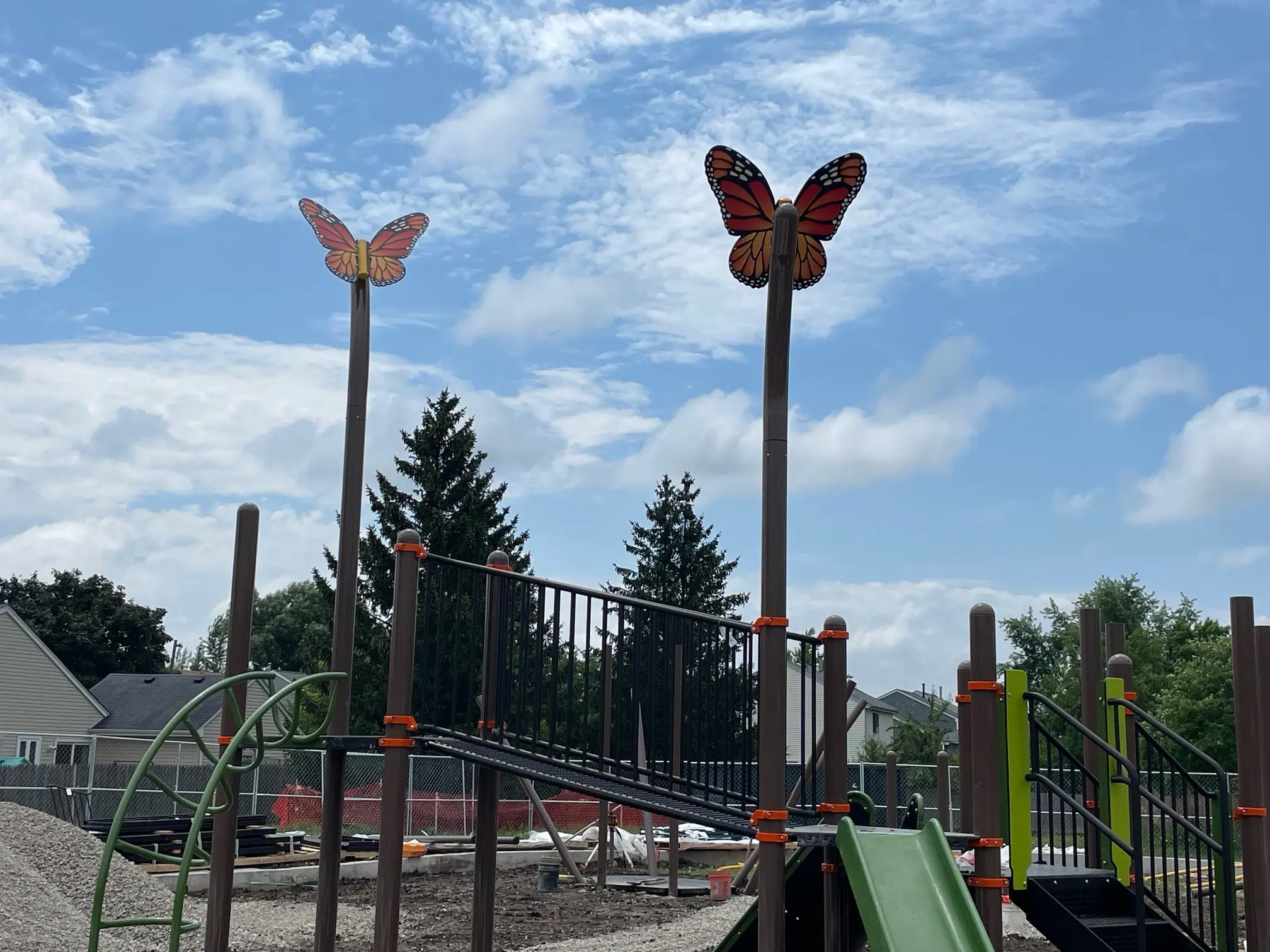 a butterfly statues at a playground