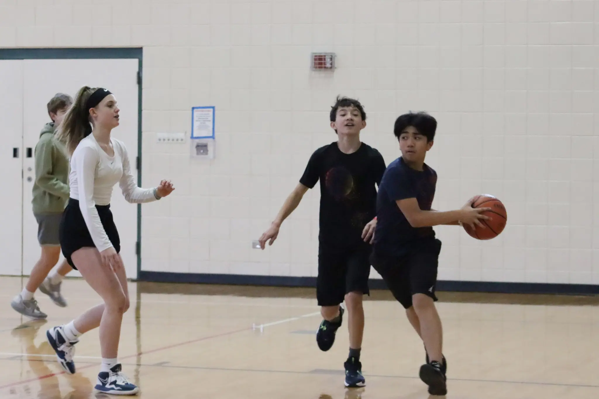 a group of people playing basketball