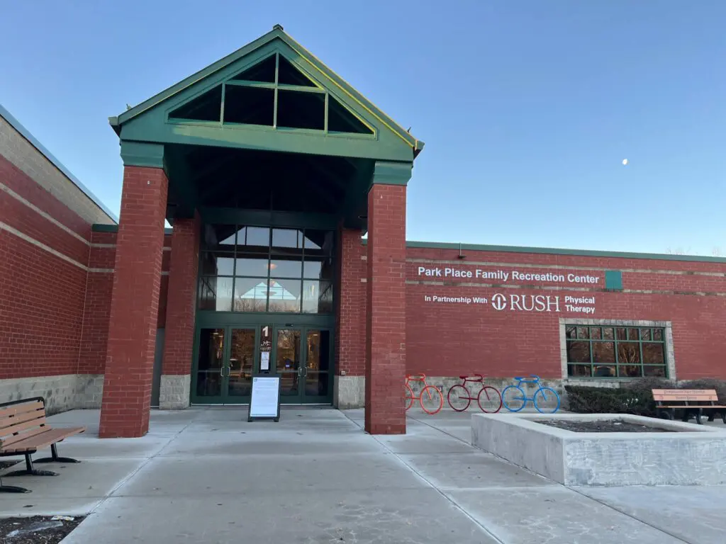 a brick building with a sign and a bike rack