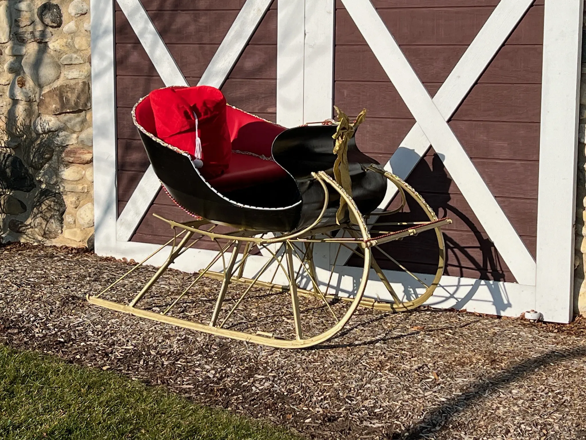 a black and gold sleigh with red cushion