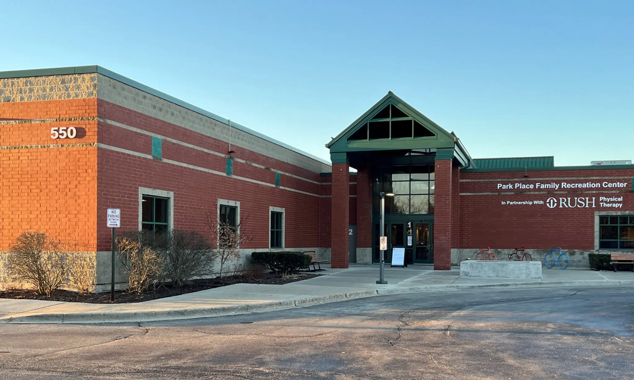 a brick building with a green roof