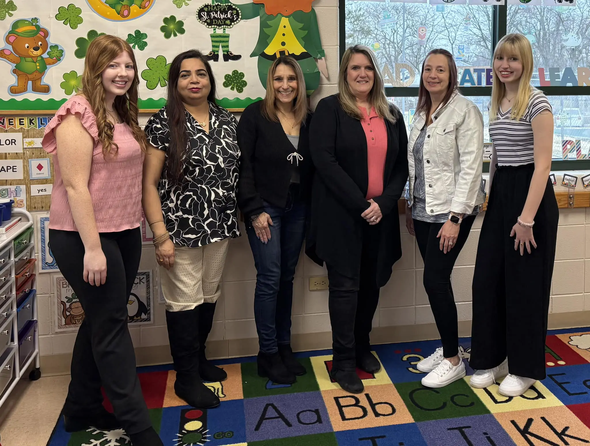 a group of women standing in a classroom