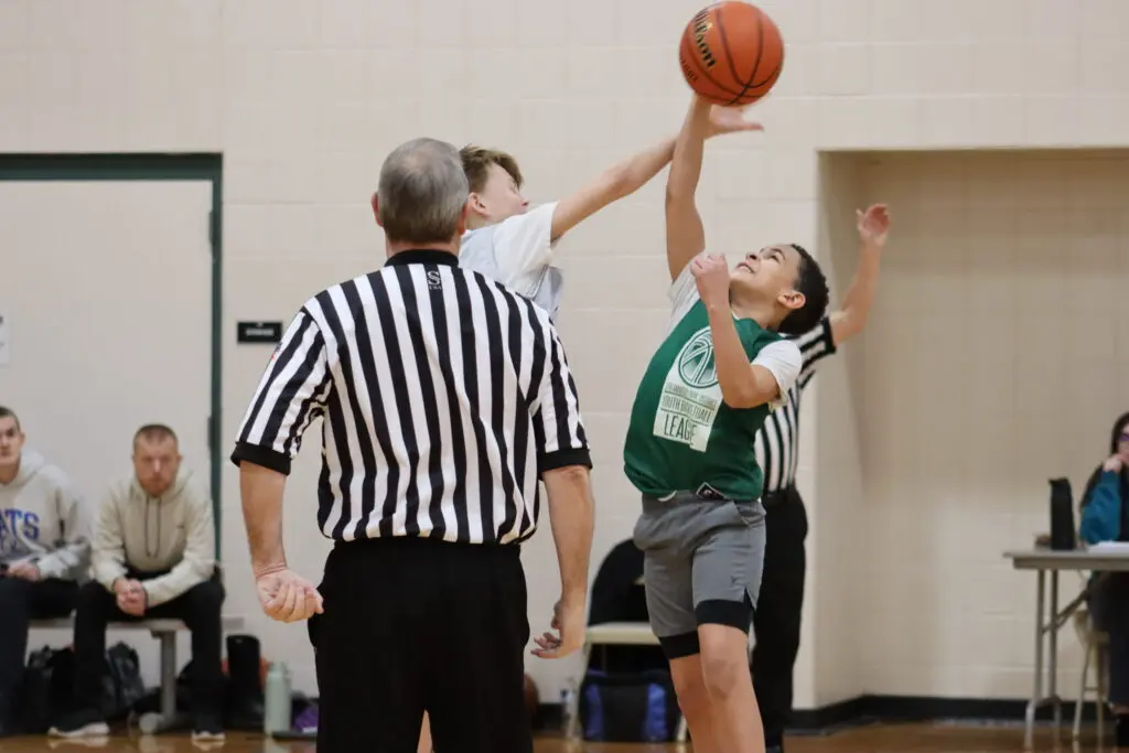 a child reaching for a basketball