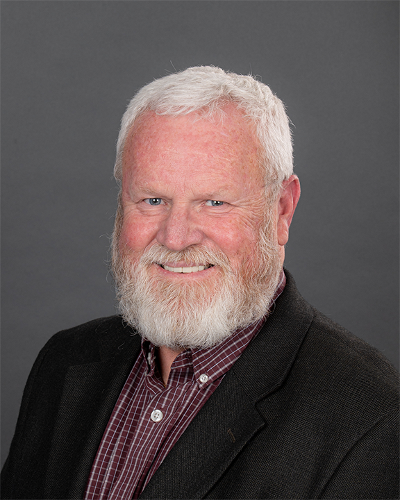 a person with a beard smiling