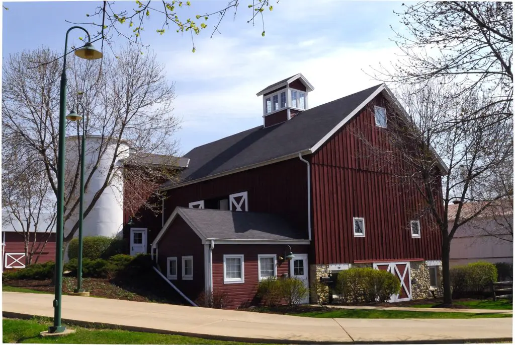 a red barn with a white tower