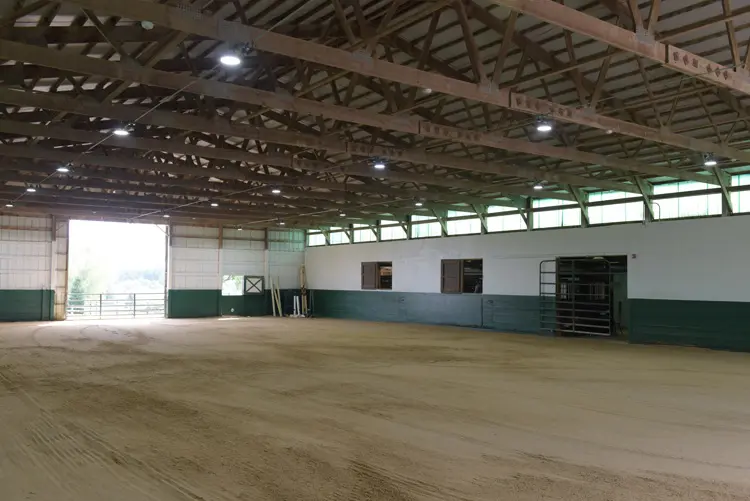 an empty barn with a dirt floor