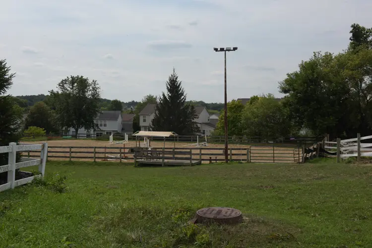 a horse riding arena in a field