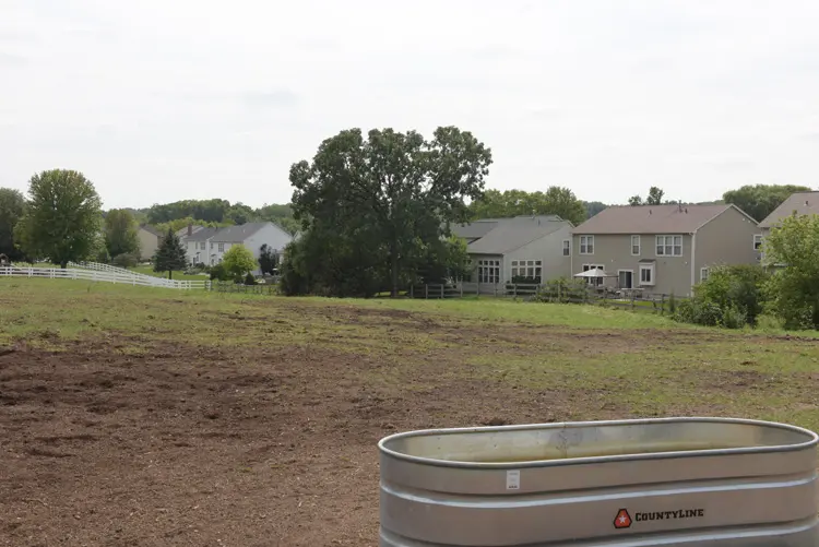 a large field with a large metal tub