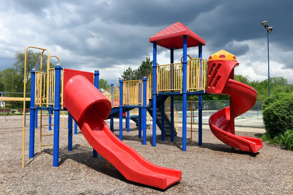 a playground with red and blue slides