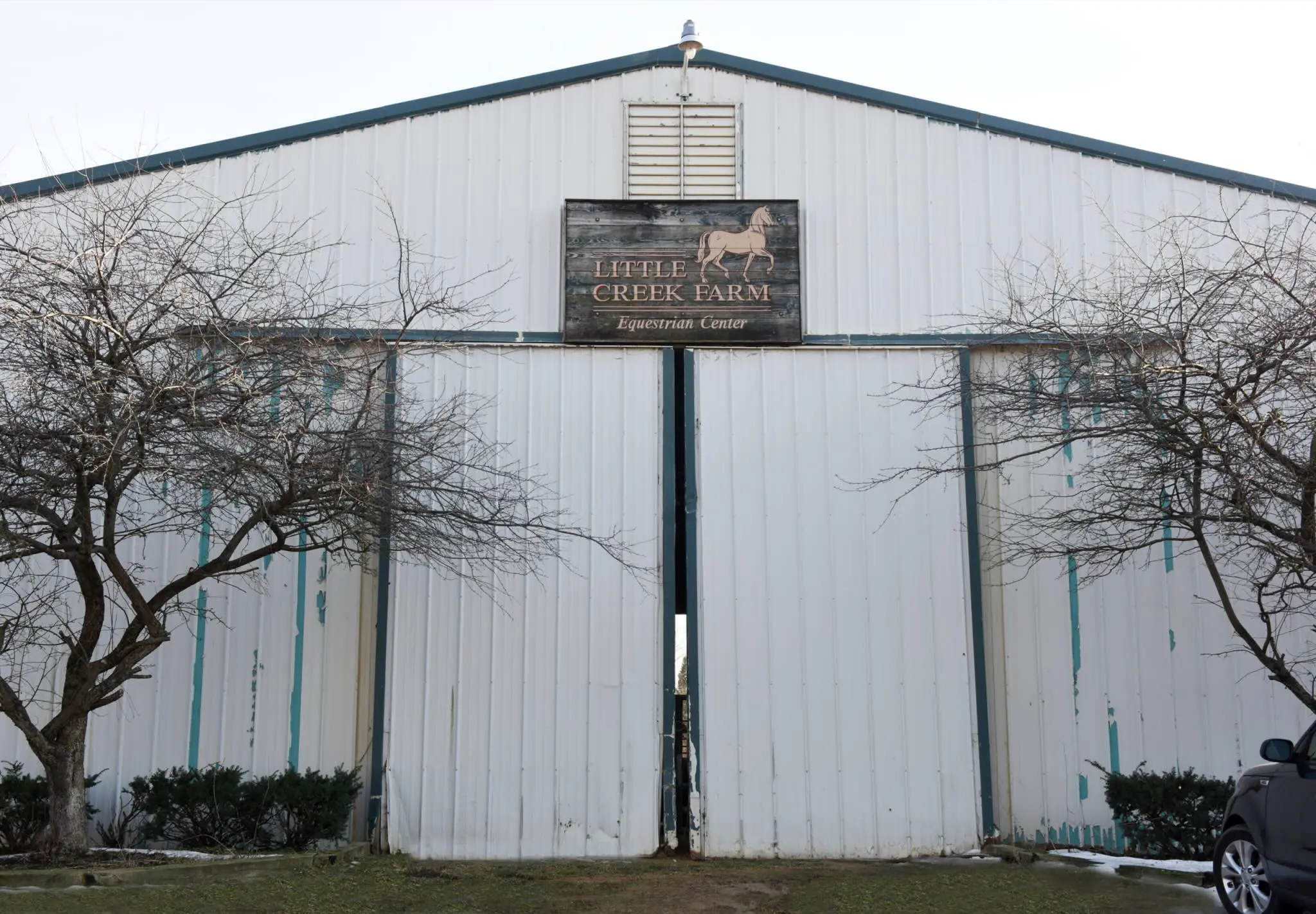 a white barn with a sign on it