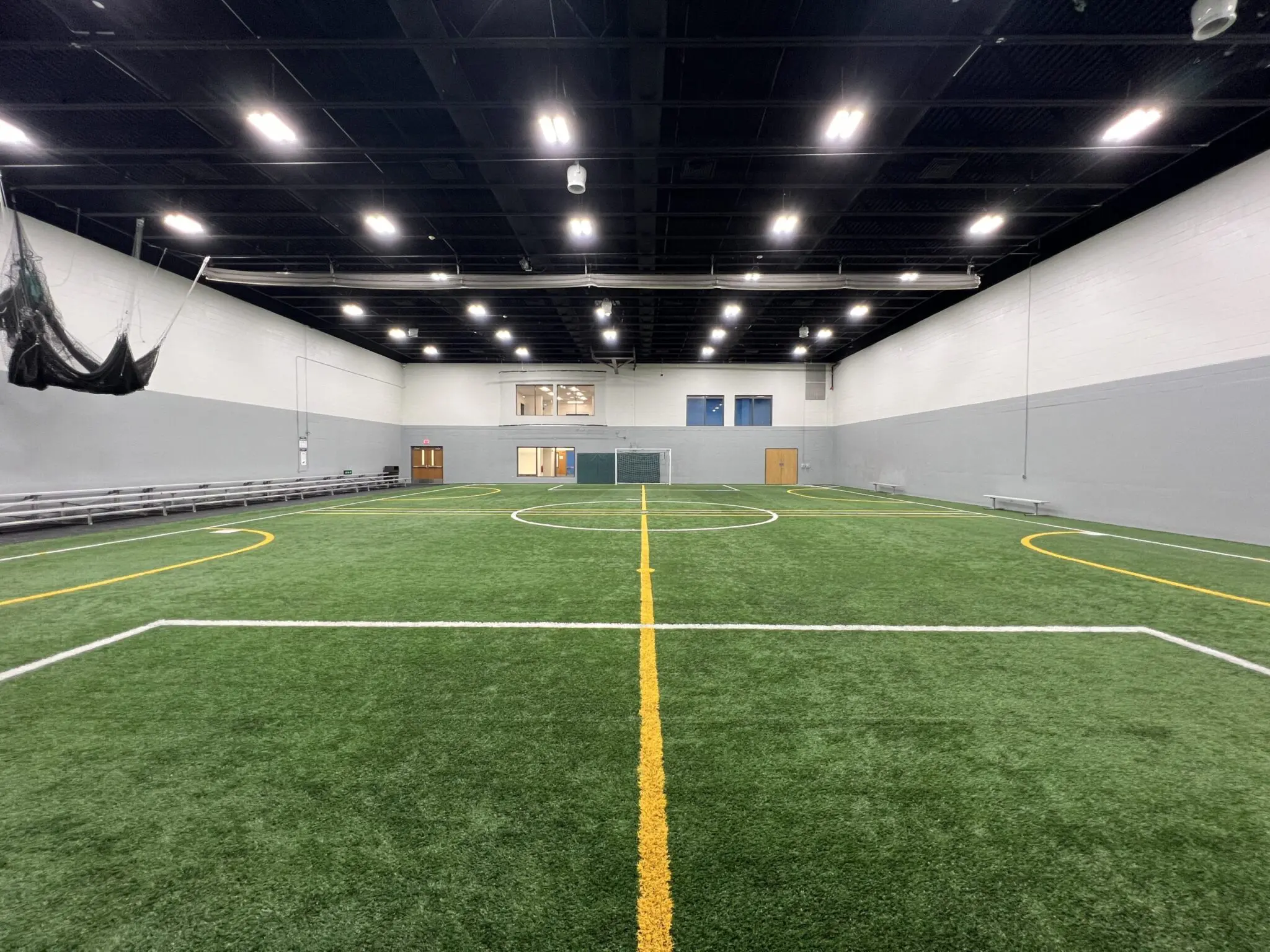 a indoor football field with a yellow line
