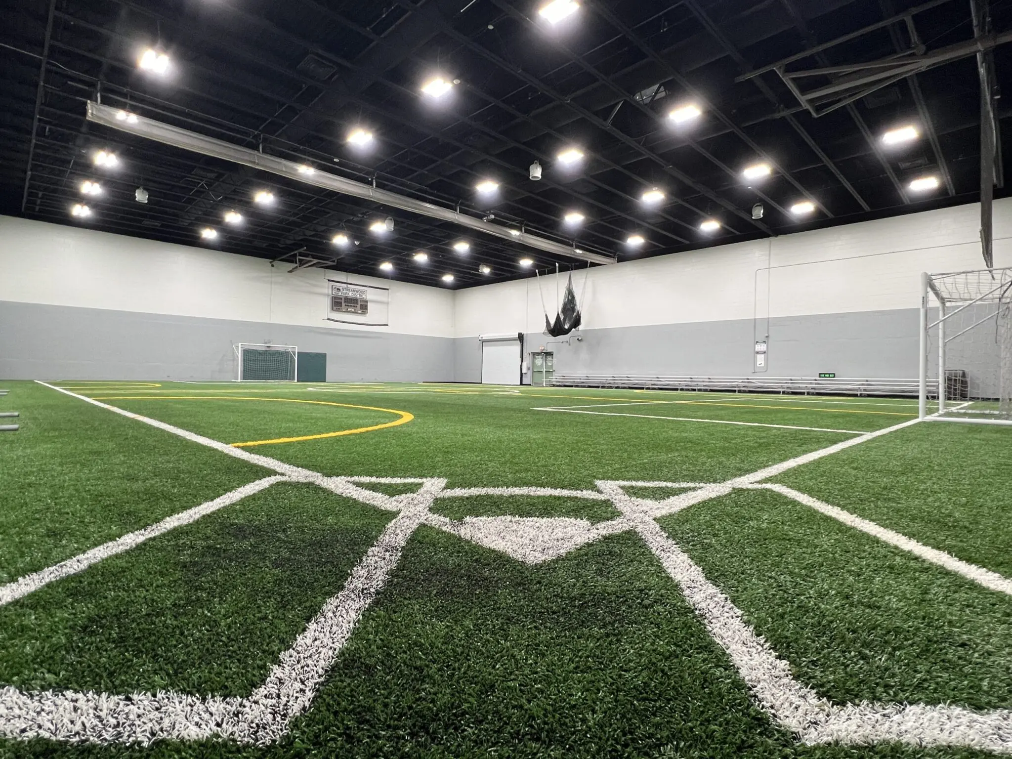 a indoor football field with white lines