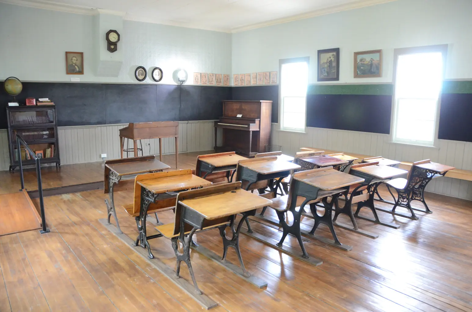 a room with desks and piano