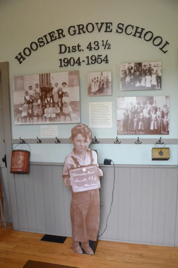a cardboard cutout of a child holding a sign