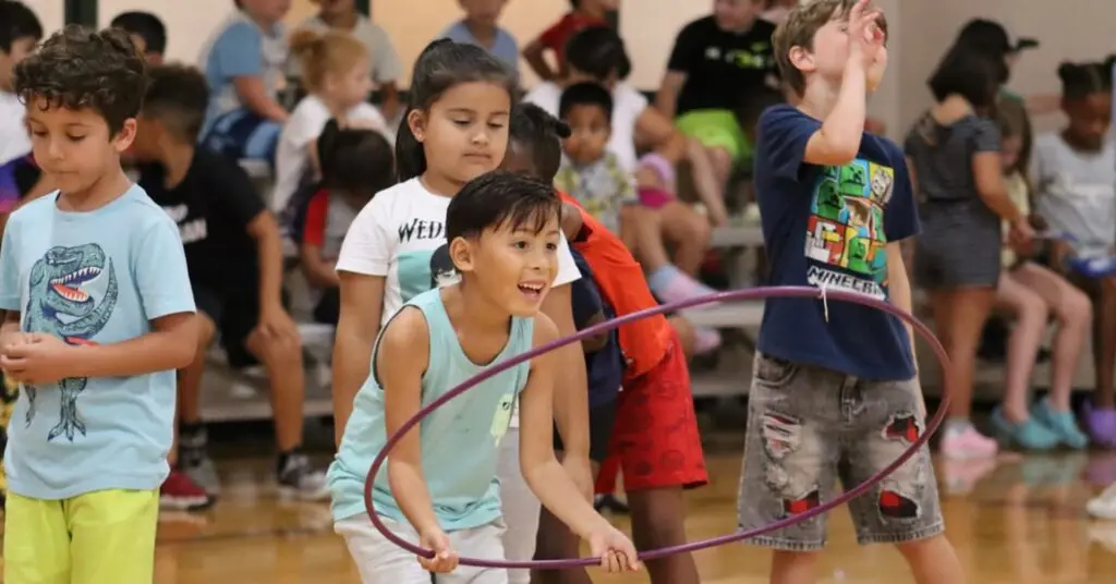 a group of children playing with a hula hoop