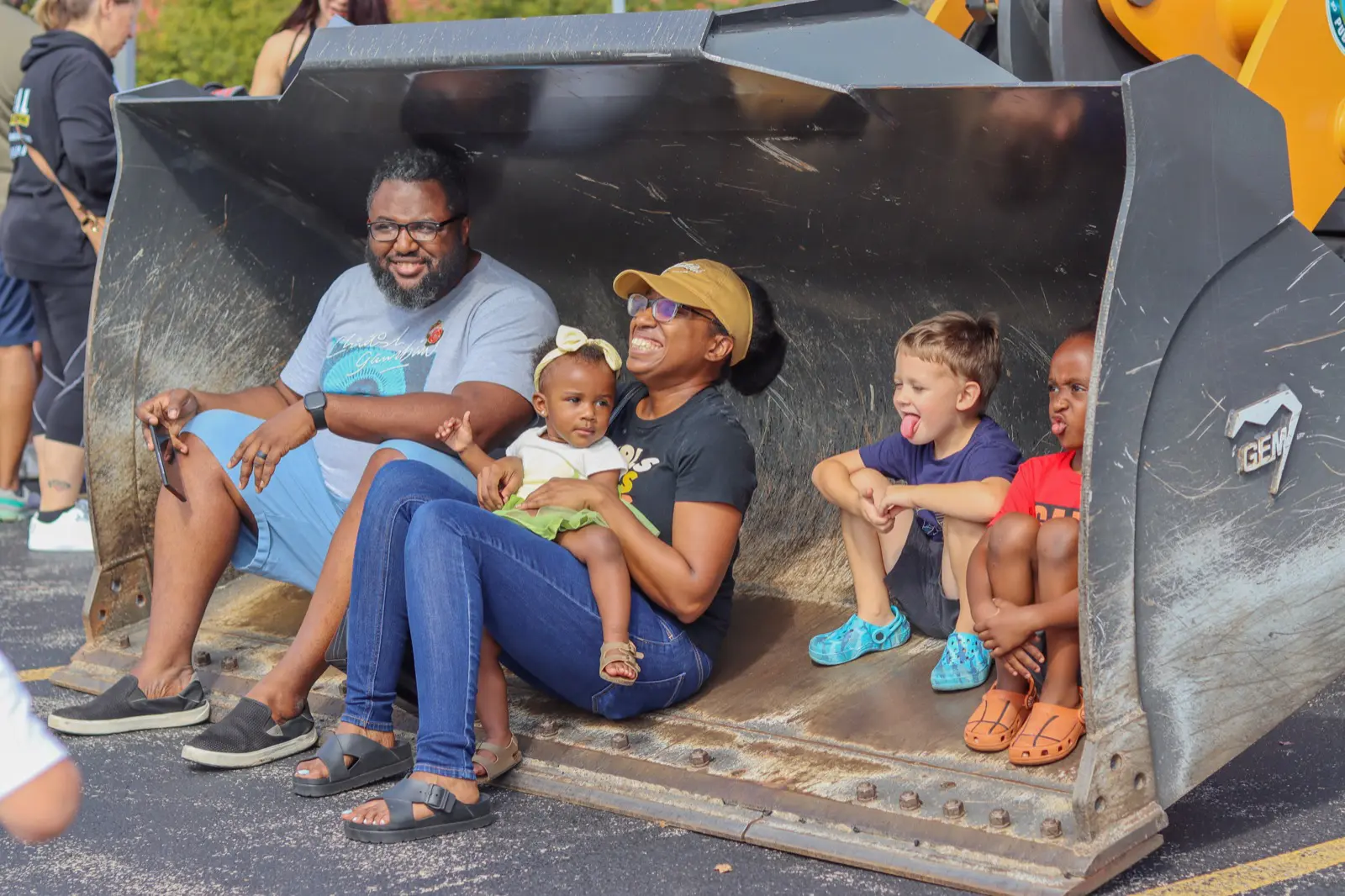 a group of people sitting in a bucket