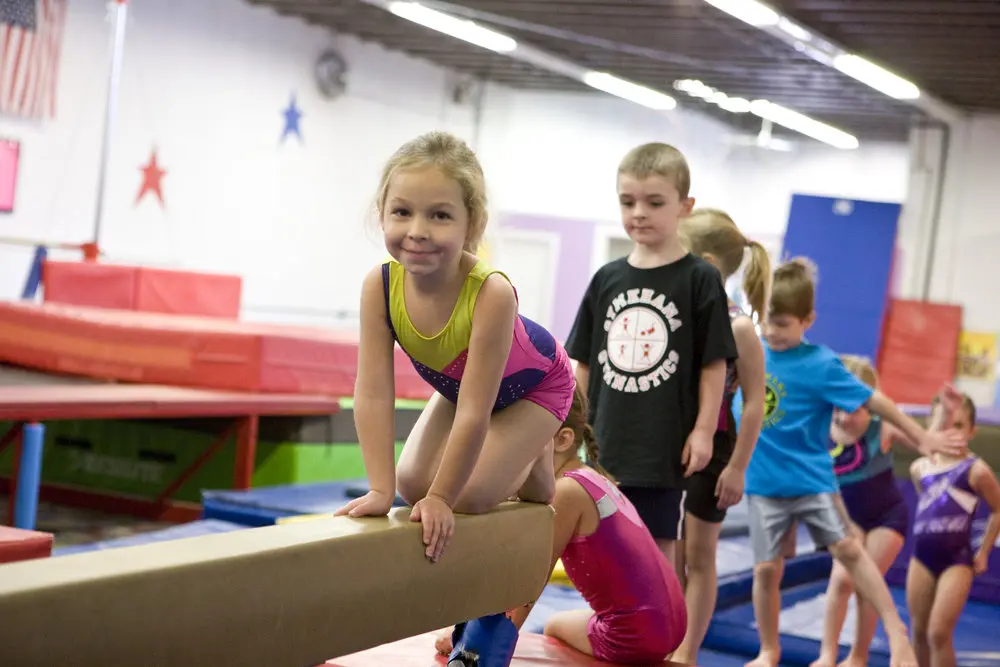 a young child on a balance beam