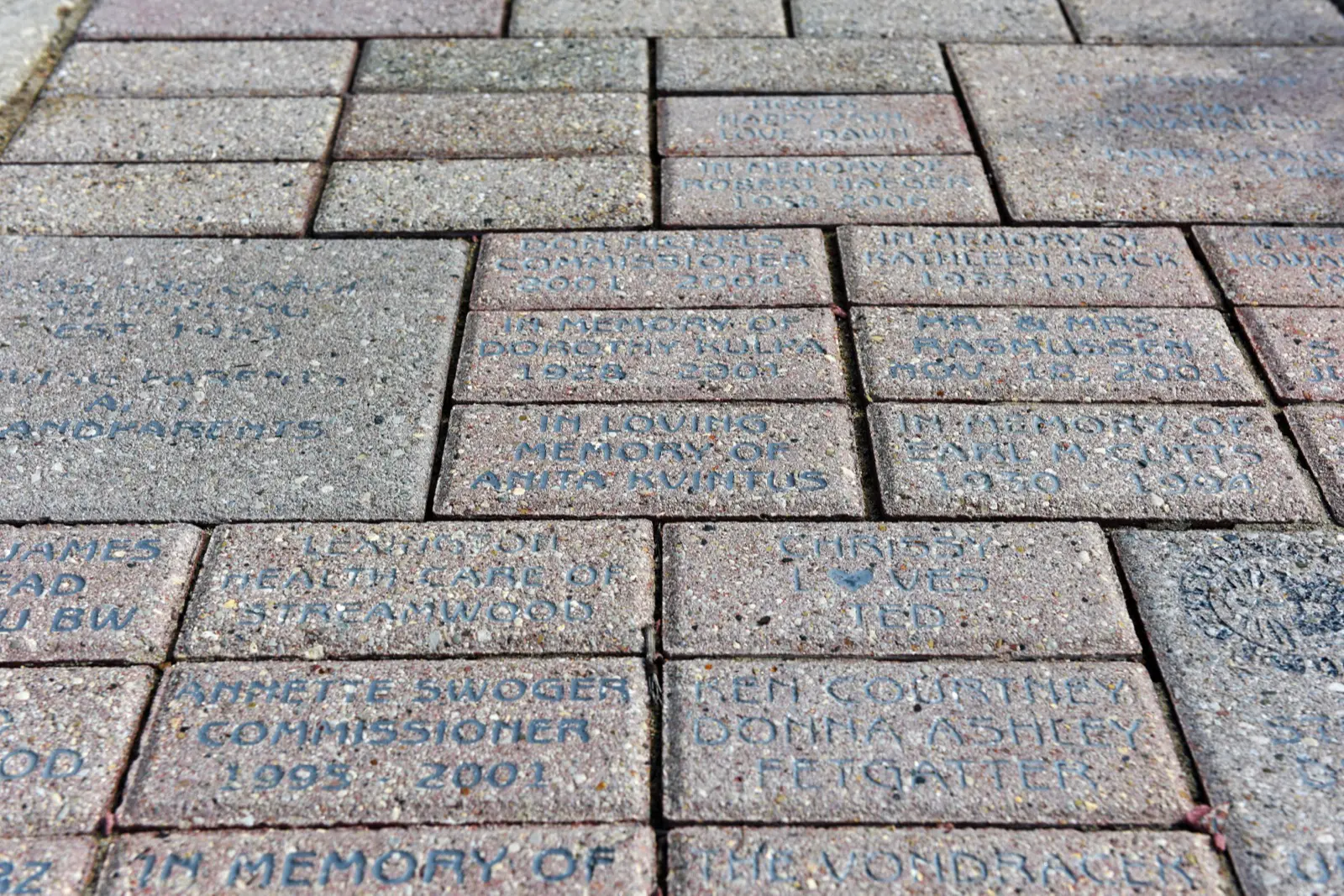 a brick walkway with engraved text