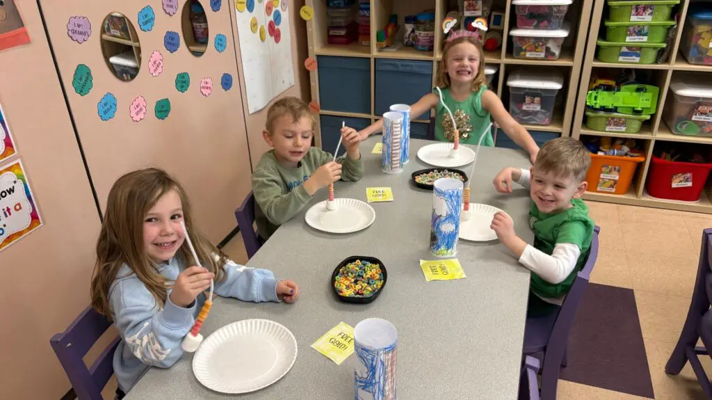 a group of kids sitting at a table