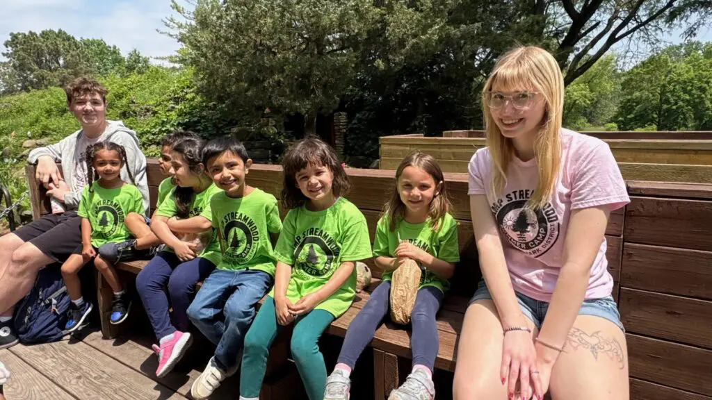 a group of children sitting on a bench